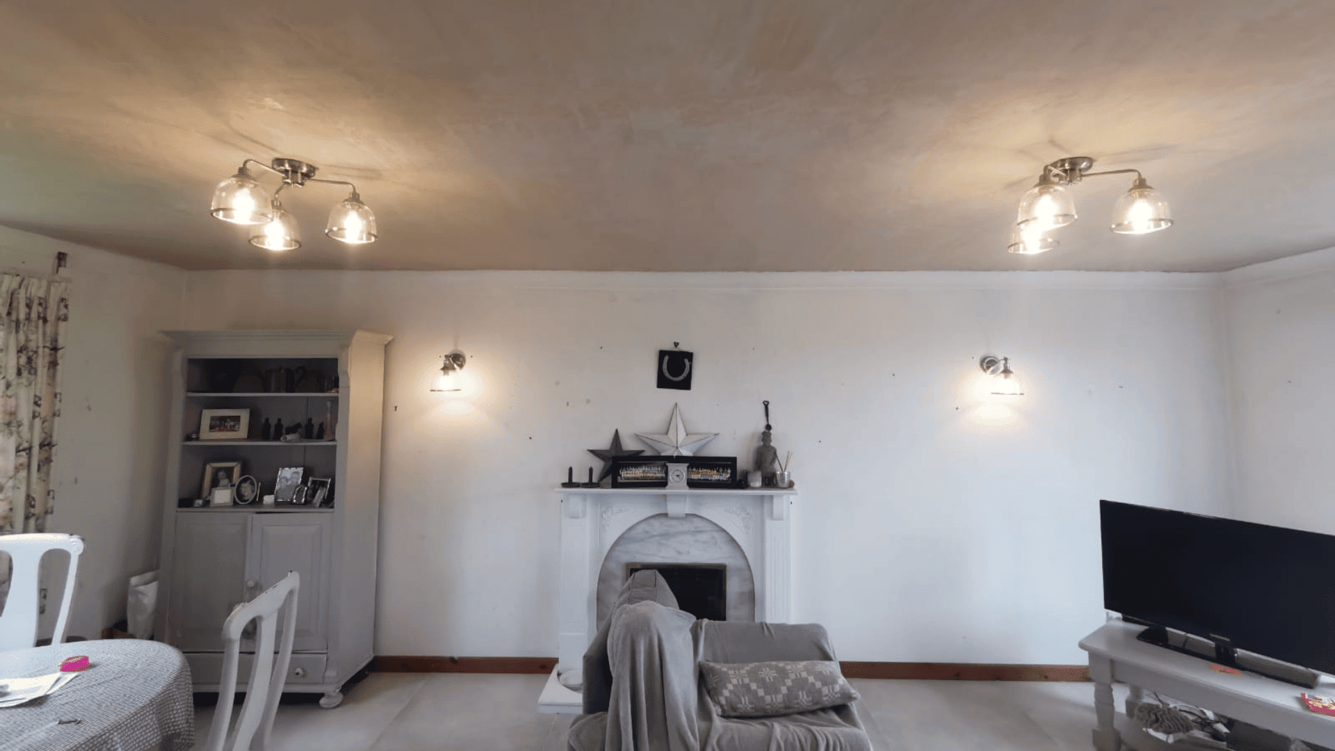 Living room with new ceiling spotlights and wall lights fitted
