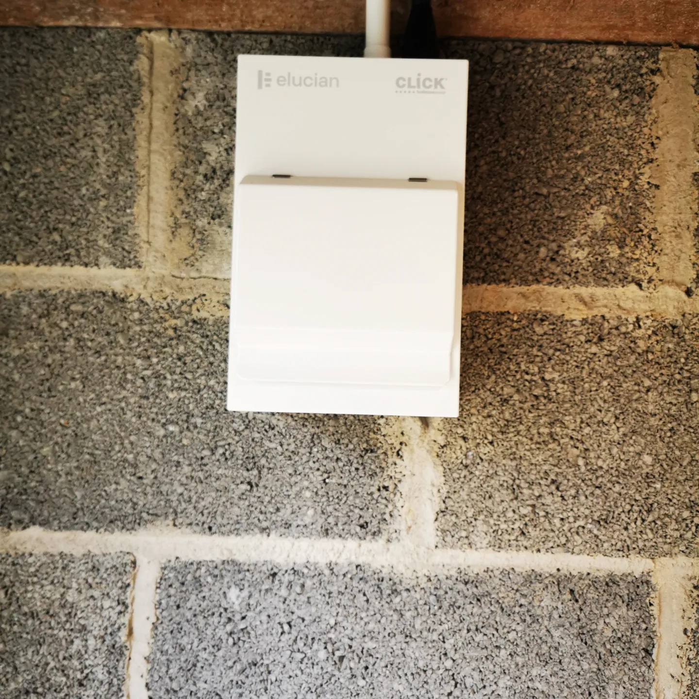 New consumer unit fitted on the blockwork wall