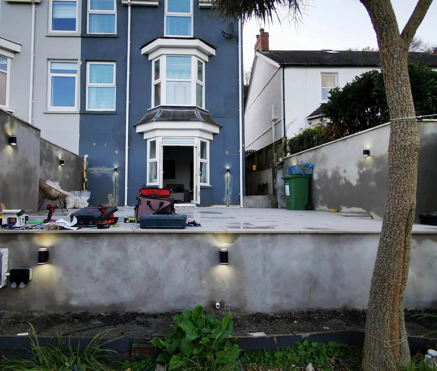 Rendered patio wall with the new wall lights fitted