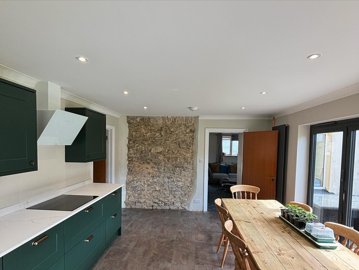 The finished green kitchen with down lights