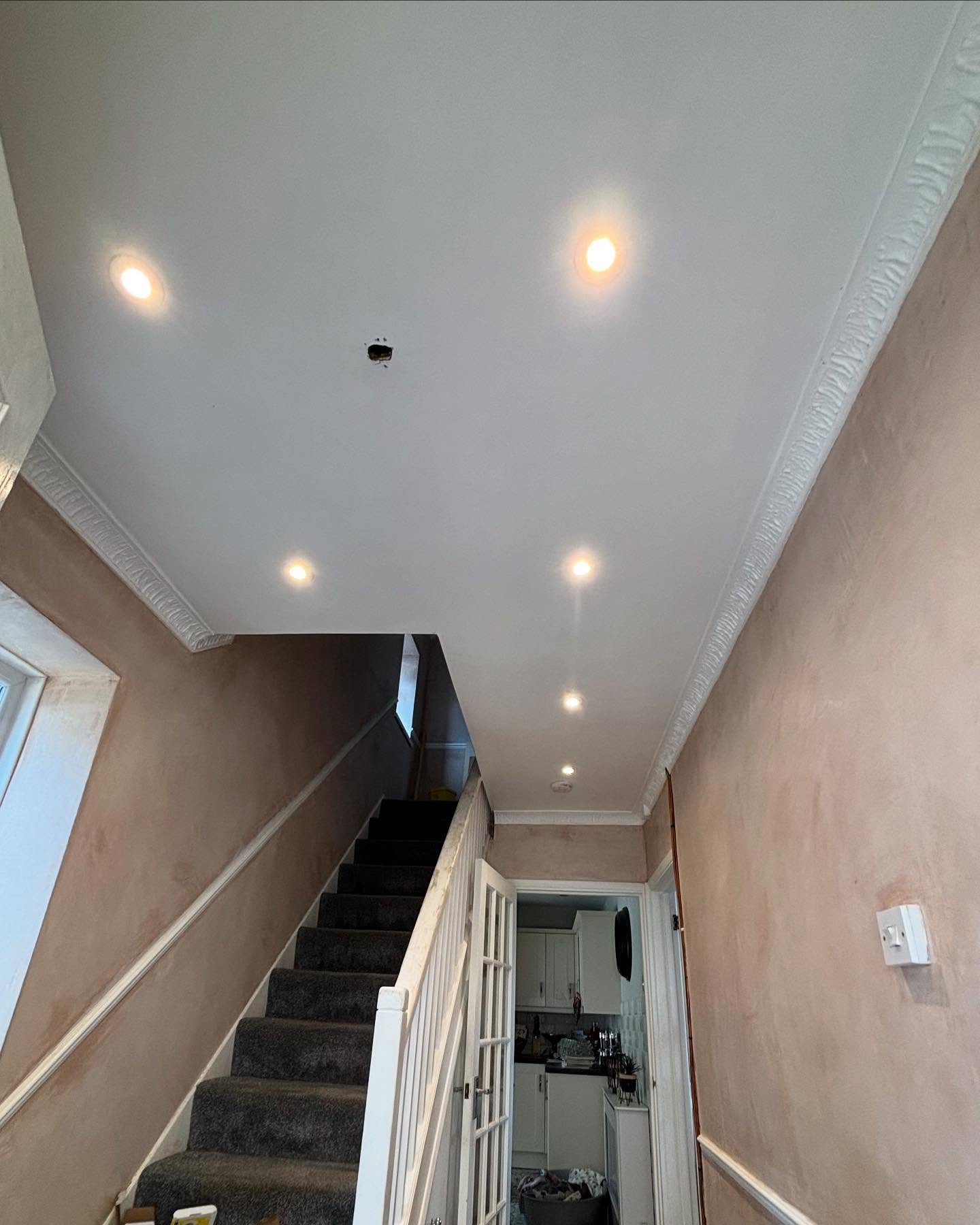 The same hallway with new down lights over the stairs